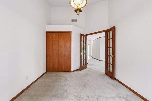 Main-level second bedroom offers flexible space for guests, a home office, or den.