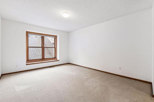Upper-level bedroom offers another spacious and private retreat.