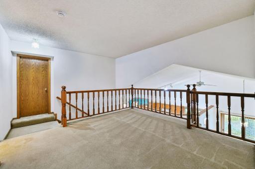 Open upper-level loft/family room provides a versatile second living space overlooking the great room.