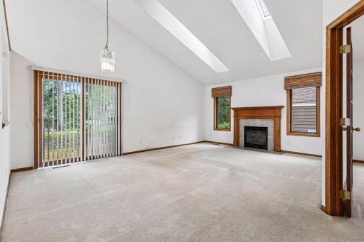 Bright, vaulted great room with skylights, a gas fireplace, and abundant natural light.