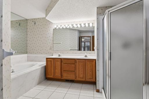Main-level full bath with separate tub and shower, conveniently connected to the primary bedroom.