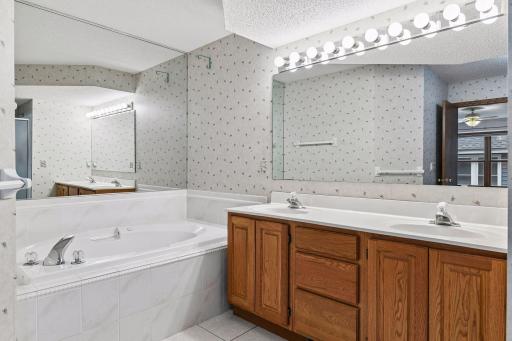 Spacious main-level full bath with dual-sink vanity and excellent storage.