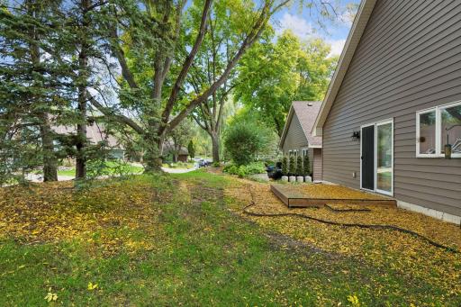 End-unit setting provides added green space, mature trees, and a more private feel.