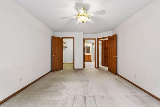 Spacious main-level primary suite provides comfortable one-level living.