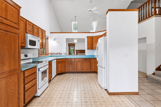 Vaulted kitchen with skylights, generous cabinet space, and an open connection to the main living areas.