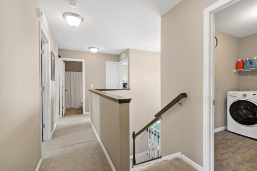 Upon ascending the stairs, this open hallway leads to all four bedrooms and the upper level laundry room.