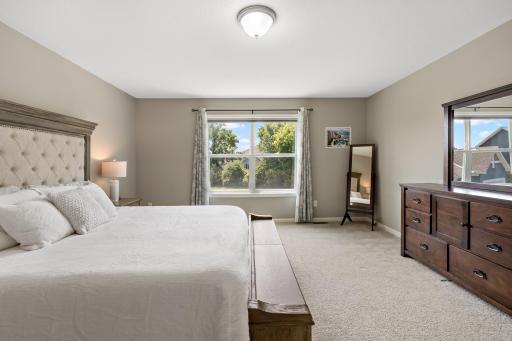 Spacious primary bedroom with views of the back yard.