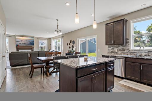 Granite countertops, pendant lighting, LVP flooring, stainless steel appliances.