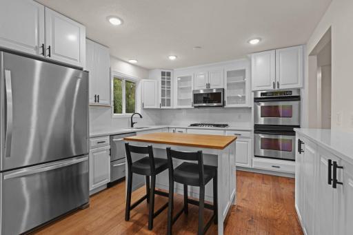 Perfectly appointed chef's kitchen, complete with center island, double wall oven, gas cooktop, microwave, loads of cabinet space and glass door cabinets.