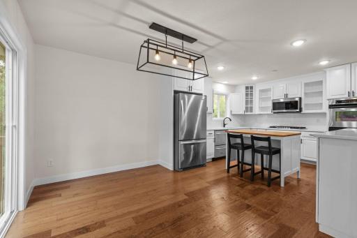 Dining/kitchen. Lots of natural lighting and beautiful new light fixtures.