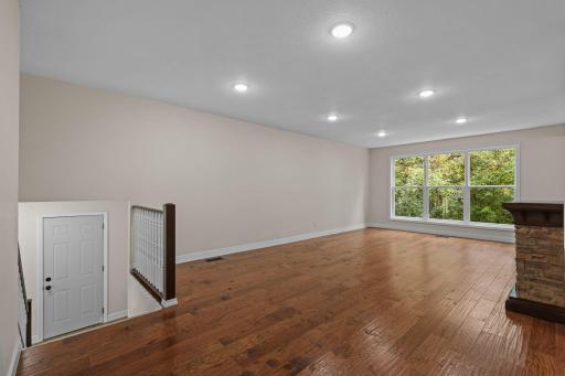 Hand scraped hickory hardwood floors throughout the living, dining, and kitchen.