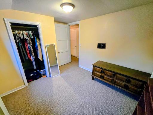 East bedroom has closet, carpet, & 2 windows.