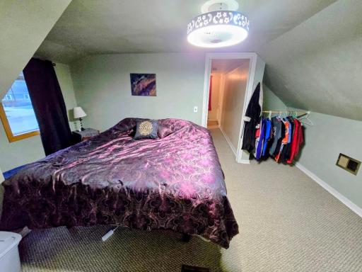 Carpeted and no closet- but largest room, this is a king size bed!