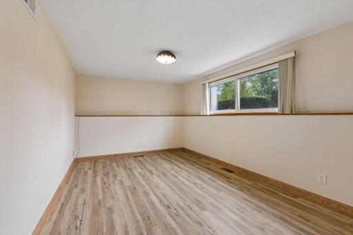 Spacious, refreshed lower-level family room with new flooring