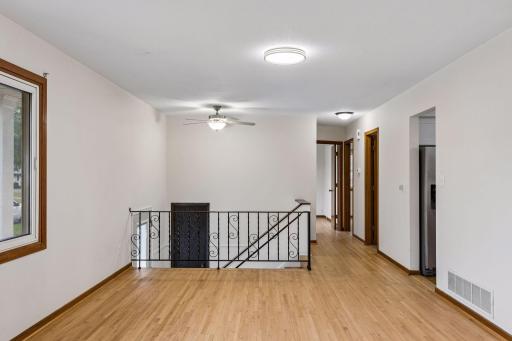 Refinished hardwood floors extend throughout the main level