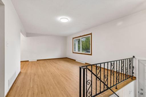 Spacious living room with beautifully refinished hardwood floors