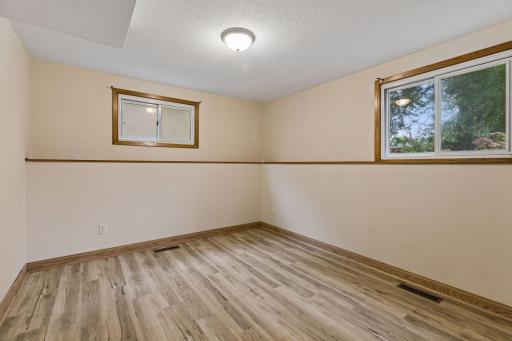 Spacious lower-level fourth bedroom with lots of natural light