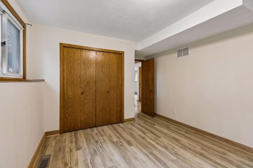 Spacious lower-level fourth bedroom with beautiful new flooring