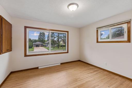 Main-level bedroom with refinished hardwood floors and abundant natural light