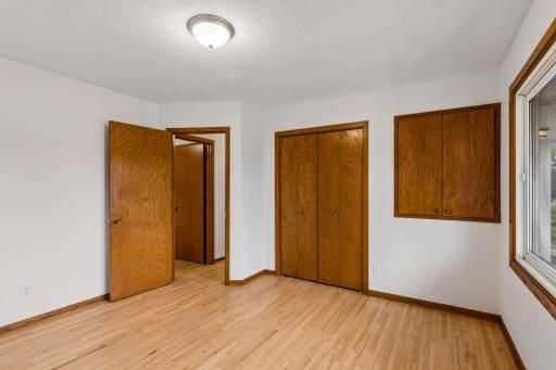 Main-level bedroom with refinished hardwood floors and abundant natural light
