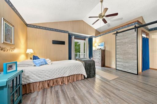 Primary bedroom offers a balcony, walk in closet and private bathroom.