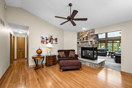 Stone fireplace with a seating area and access to the living room