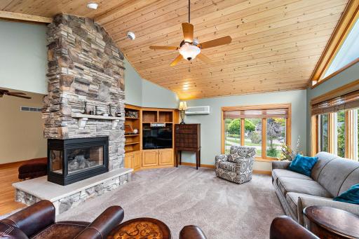 The gas fireplace with the full stone chimney