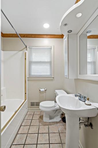 Full bathroom with pedestal sink.