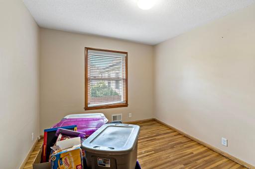 First bedroom is 12' x 10' with hardwood flooring.