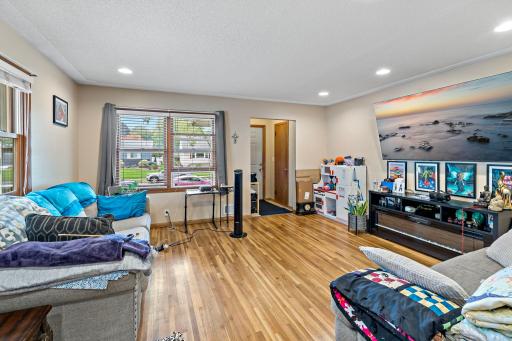 Original hardwood flooring in the 15' x 14' living room with large windows.