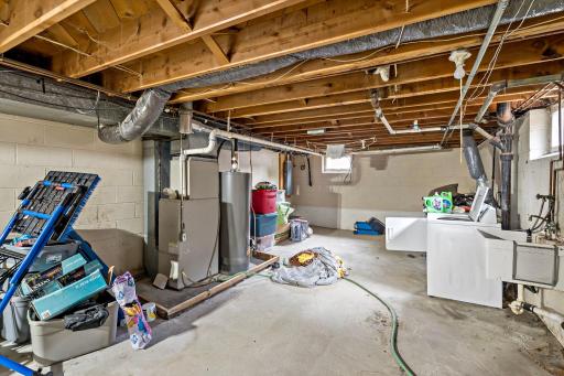 Lower level utility area in Unit 5751. Washer and dryer are owned by the tenant. Water heater was replaced in 2023.