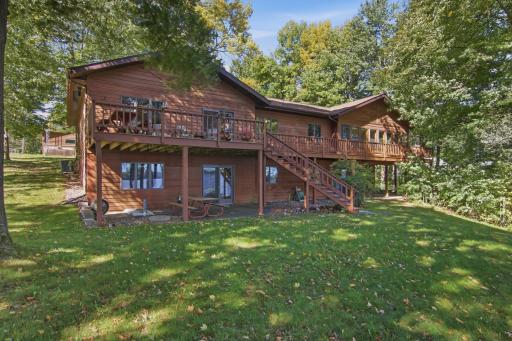wrap around deck has plenty of room for entertaining, enjoying early morning coffee and dining all while overlooking your back yard, shoreline and beautiful view of Red Cedar Lake