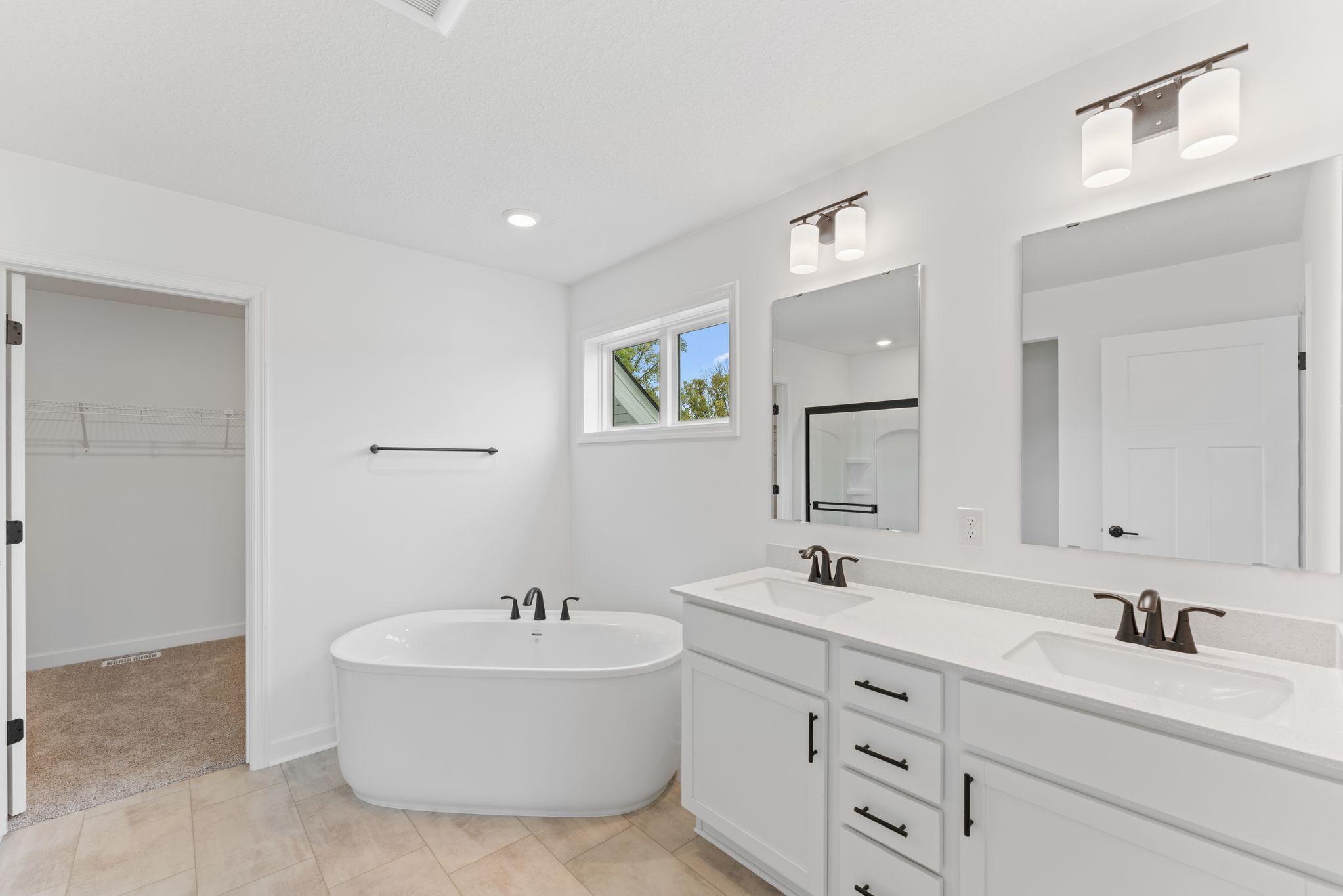 This elegant bathroom has direct access to the walk-in closet, perfect for getting ready throughout the week
