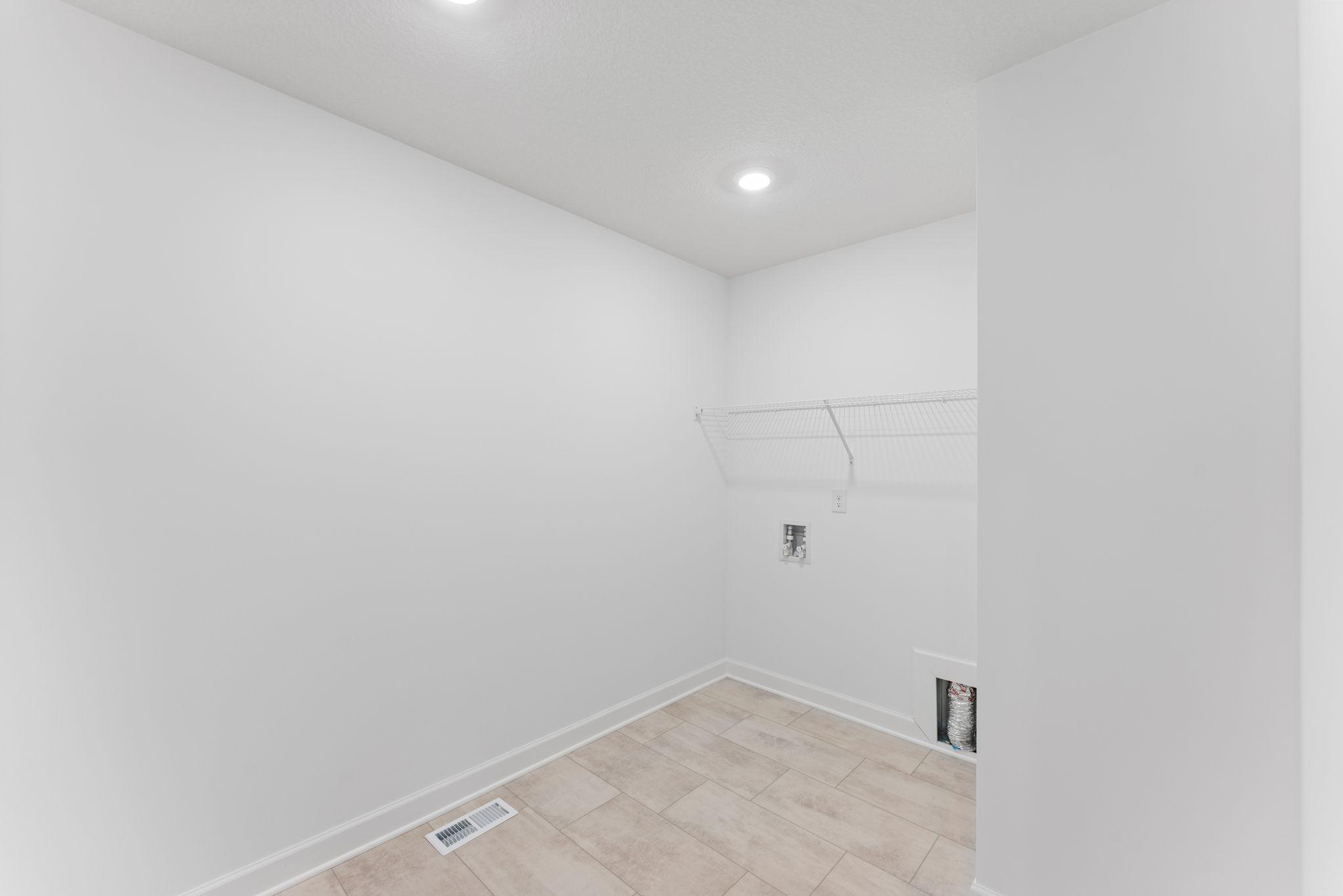 Located on the same floor as all the bedrooms is a spacious laundry room to conduct daily chores and organizational tasks. Shown here with an optional rinse sink.