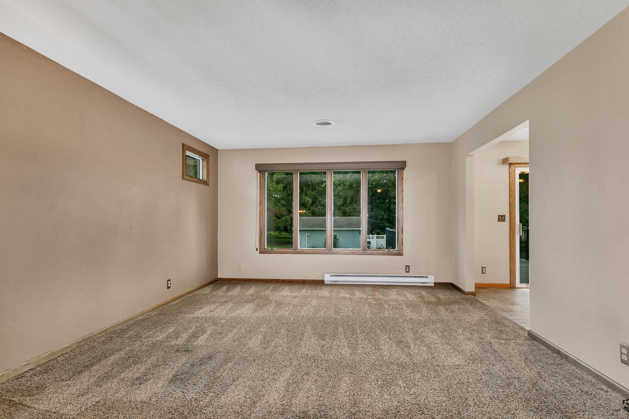 Large south facing living room window overlooks the big backyard