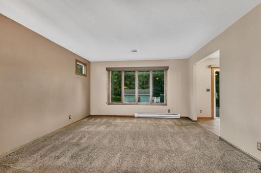 Large south facing living room window overlooks the big backyard