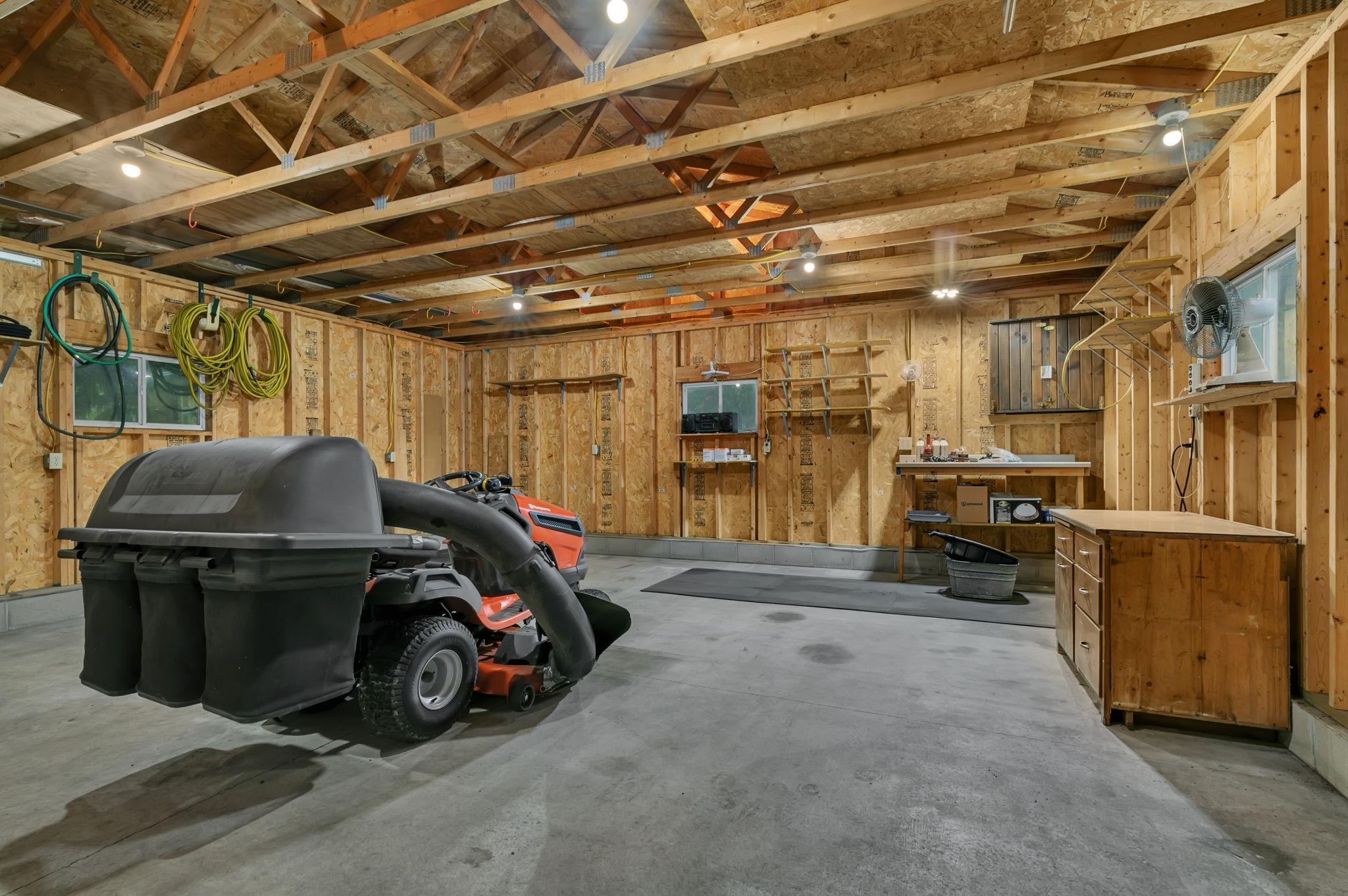 Interior of detached garage. Lawn mower does not stay.
