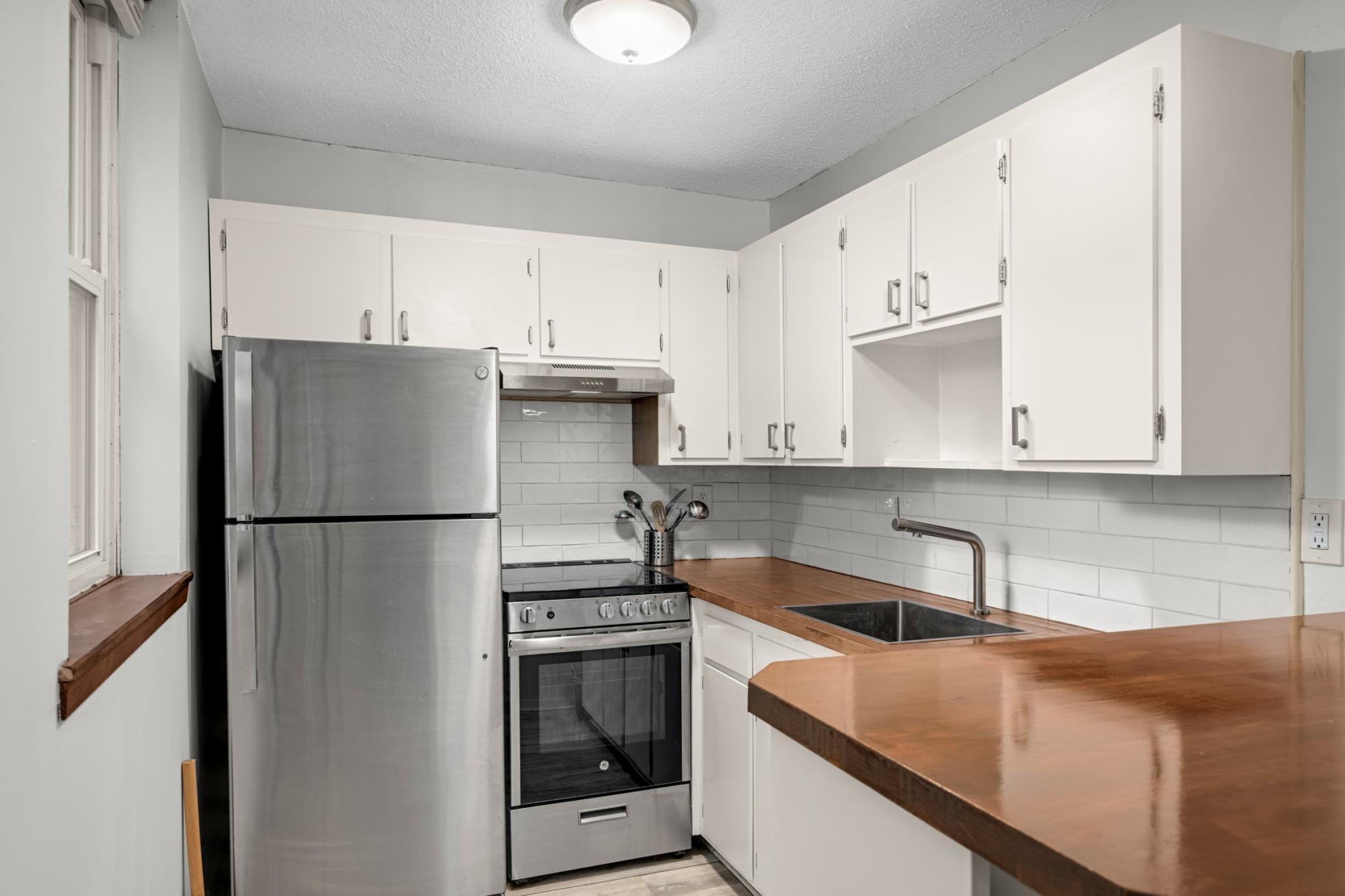 Kitchen with updated appliances and countertop.
