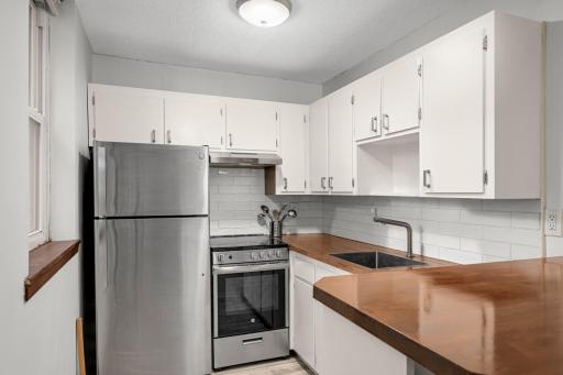Kitchen with updated appliances and countertop.