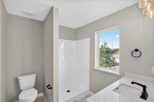 Private Primary Bath. Photo taken of another home with similar plan and finishes.
