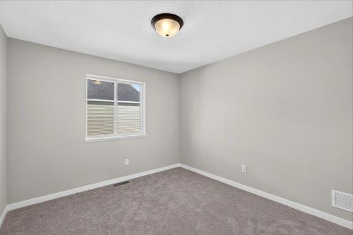 Bedroom 2. Photo taken of another home with similar plan and finishes.