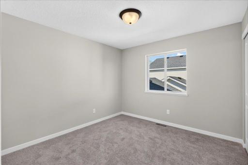 Bedroom 3. Photo taken of another home with similar plan and finishes.