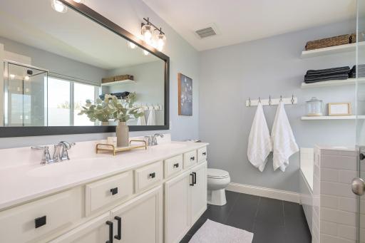 Dual sink vanity, separate bath and shower complete the Primary Bathroom