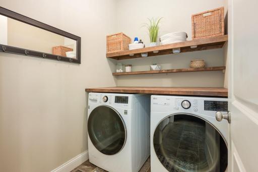 Beautifully designed main-level Laundry Room with custom shelving