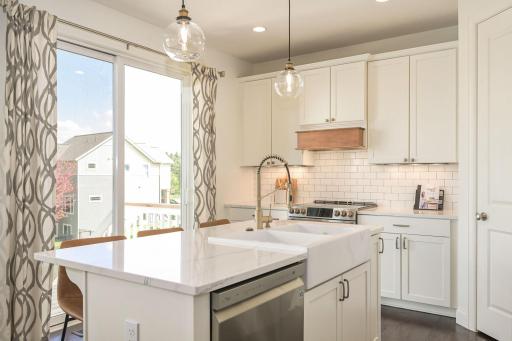Bright, open Kitchen with quartz countertops and abundant cabinetry
