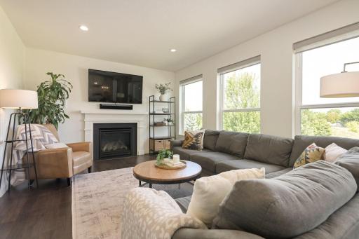 Inviting Living Room with a gas fireplace and beautiful backyard views!