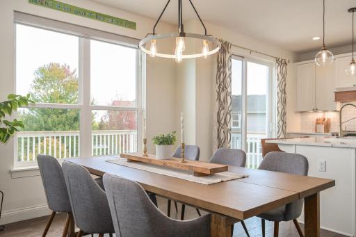 Sun-drenched Dining Area with oversized windows and views of private backyard!