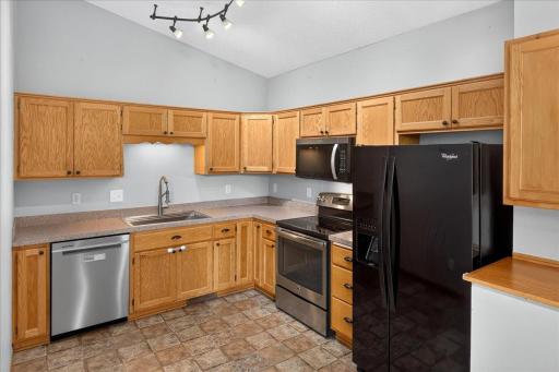 Updated farmhouse sink with gooseneck faucet. Kitchen with Stainless Steel Appliances