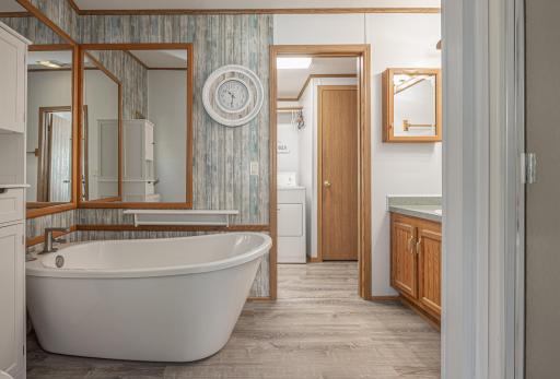 Bathroom with large tub off primary bedroom