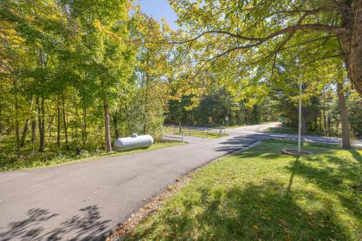 Asphalt driveway with additional parking space